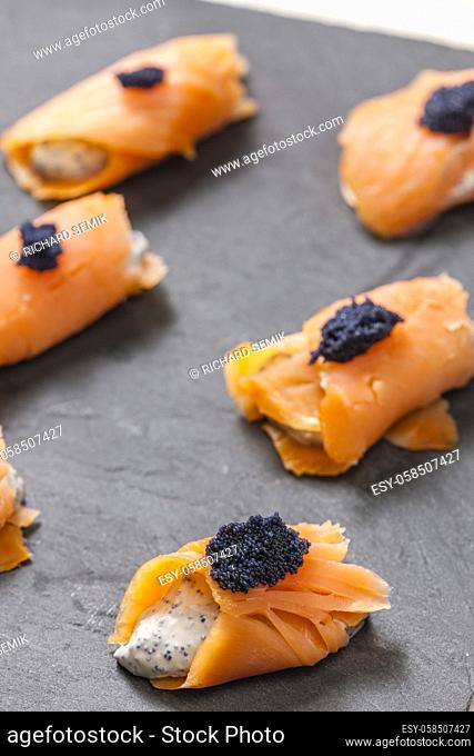 smoked salmon rolls filled with cream cheese and black caviar