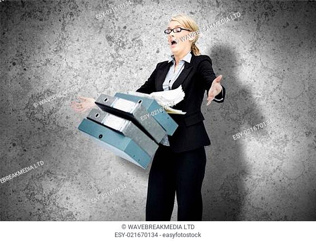 Woman dropping her workload on grey wall background