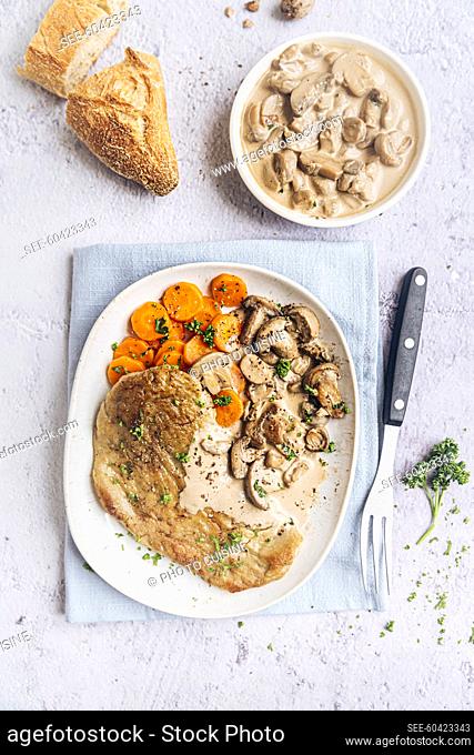 Vegetarian seitan escalope with mushrooms, carrots and arsley