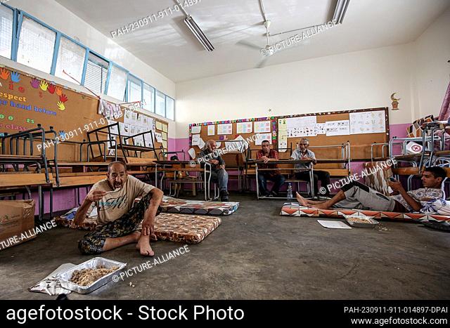 11 September 2023, Lebanon, Sidon: Palestinian refugees who fled their Ain al-Hilweh camp take shelter in a classroom inside a United Nations Relief and Works...