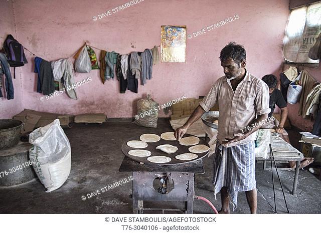 Chapati maker in the wholesale market at the Khari Baoli Spice Market, Old Delhi, India
