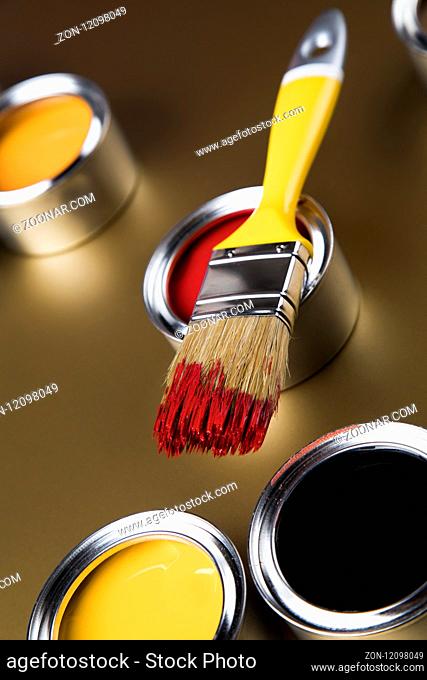 Paintbrush on cans with color