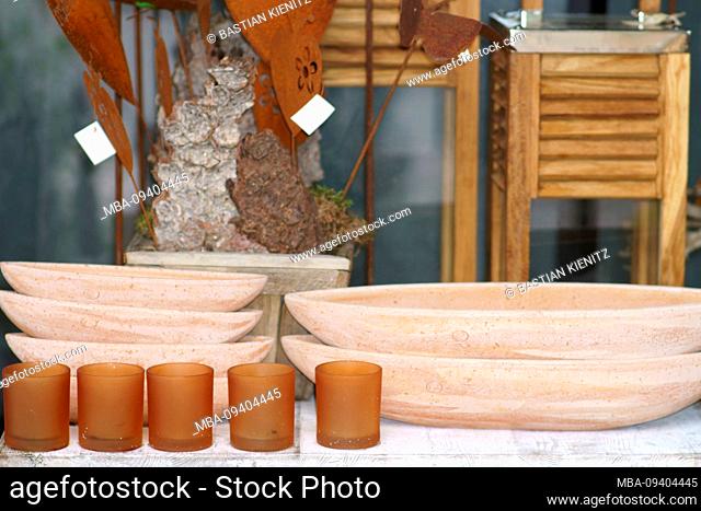 Various clay bowls or bowls made of terracotta on a sales stall with artisanal objects