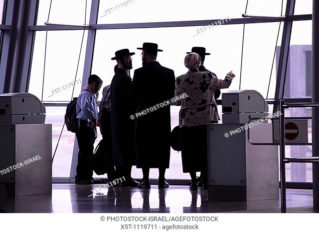 Israel, Ben Gurion Airport, Silhouette of passengers in the departure lounge awaiting their flight