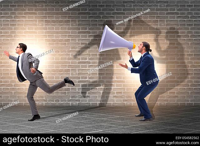 Businessman shouting through the large loudspeaker
