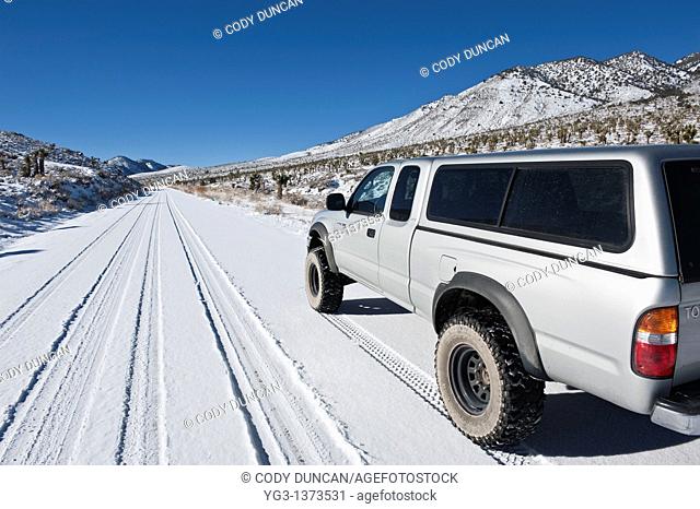 4 wheel drive truck on Snow covered high desert road, Death Valley national park, California