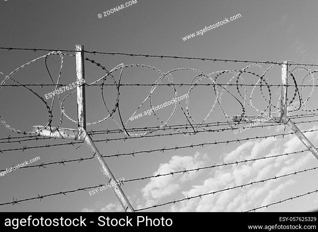 and cloudy sky in oman barbwire in the background
