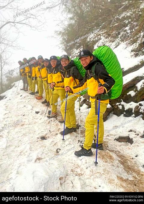 PRODUCTION - 26 January 2022, Nepal, -: Members of a group of Sherpa mountaineers line up on their way to the base camp of Mount Cho Oyu in the Himalayas