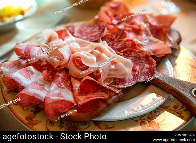 Typical various italian salami, servided on plate at restaurant