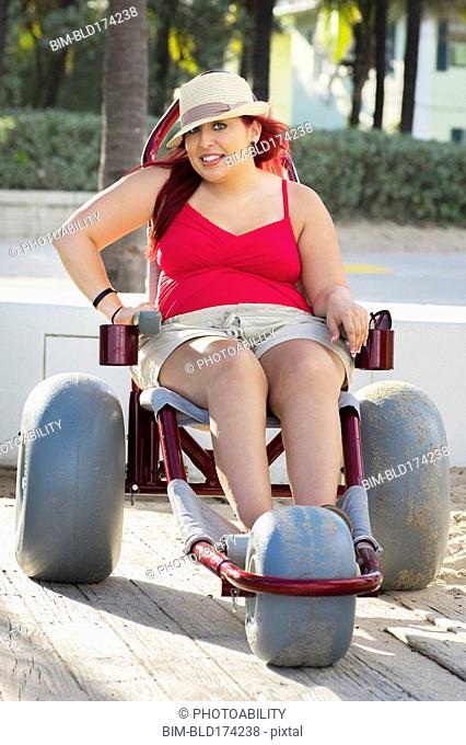 Paraplegic woman in wheelchair on walkway