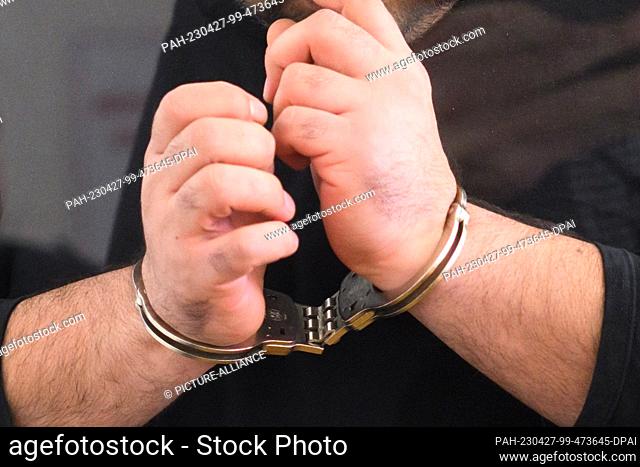 27 April 2023, Lower Saxony, Hanover: The defendant enters the courtroom at the Hanover Regional Court in handcuffs. In the trial against the 24-year-old