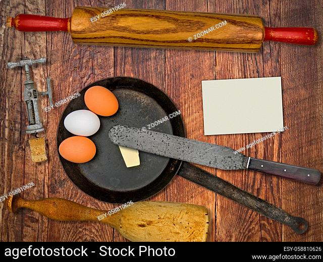 vintage utensils set, skillet, eggs, butter, space for your text on a blank business card