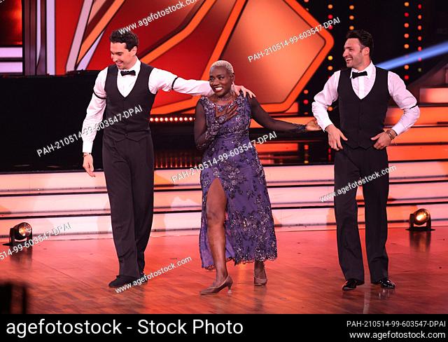 14 May 2021, North Rhine-Westphalia, Cologne: Auma Obama and professional dancer Andrzej (l) Cibis rejoice during the RTL dance show ""Let's Dance"" with dancer...