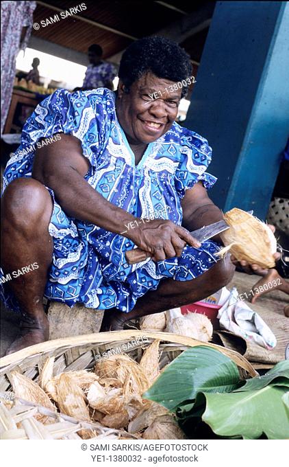 Smiling woman selling coconuts at the daily open market, Port Vila, Efate Island, Vanuatu