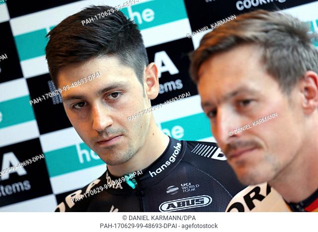 The Germany cyclist Marcus Burghardt of the team Bora - hansgrohe and his colleague Emanuel Buchmann (L) can be seen during a press conference in Duesseldorf