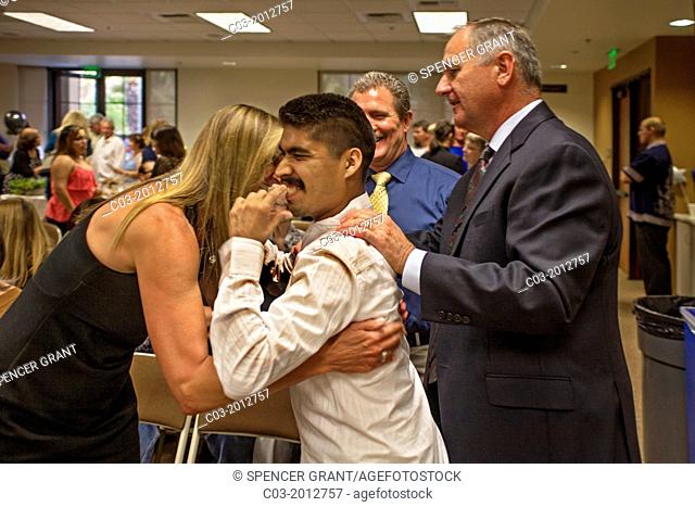 A handicapped Adult Transition Program (ATP) student is welcomed by guests at his graduation in San Juan Capistrano, CA. The ATP combines classes and community...