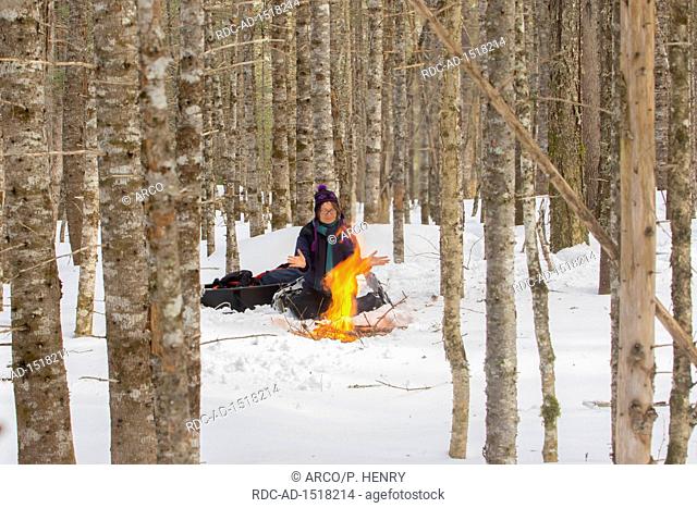 Woman at fire camp, Gaspesie national park, Gaspesie, Quebec, Canada