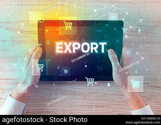 Close-up of a hand holding tablet with EXPORT inscription, online shopping concept