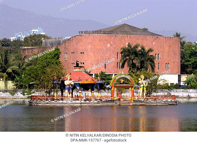 Ram Ganesh Gadkari Rangayatan Marathi drama theatre with reflection in water of Masunda lake or Talao Pali ; Thane ; Maharashtra ; India