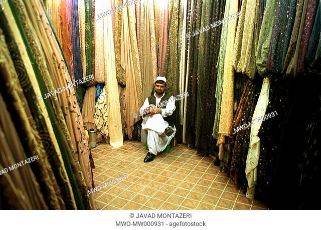 An Iarnian merchant sittin in his cloth shop in Zahedan city of Sistan & Balouchistan south eastern province of Iran