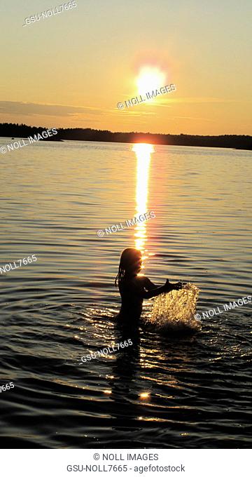 Girl Swimming at Sunset