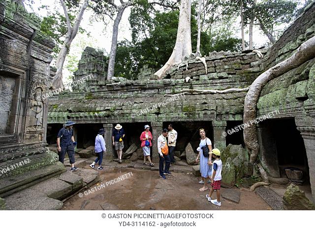 Tourists in Ta Prohm temple in Angkor Wat, Siem Reap, Cambodia. Ta Prohm is the modern name of the temple at Angkor, Siem Reap Province, Cambodia