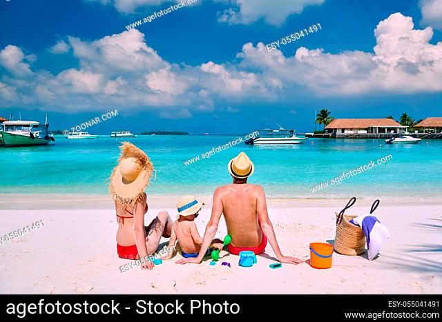Family on beach, young couple with three year old boy. Summer vacation at Maldives