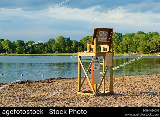 Lifeguard chair sits empty on a beach
