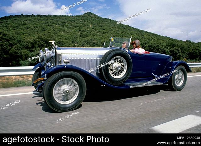 Hispano Suiza car rally - Santander to Madrid. Blue and silver sports car drives at speed on the open road in Spain