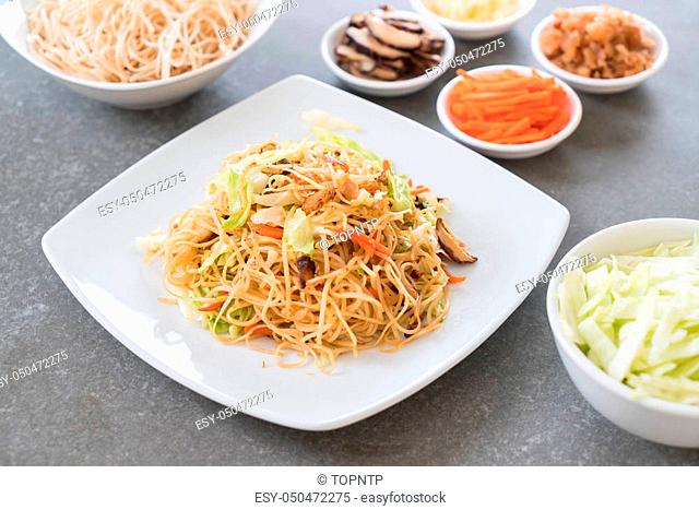 fried noodles on plate with ingredients