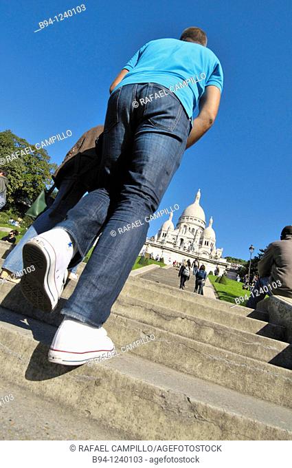 People climbing stairs in front of the Basilica Sacré-Coeur. Montmartre. Paris, France