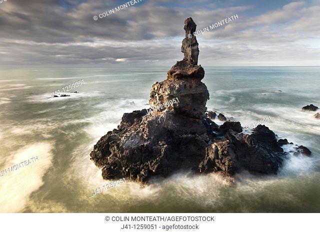 Sea stack off Tumbledown Bay, dawn, southern bays of Banks Peninsula, Canterbury, New Zealand