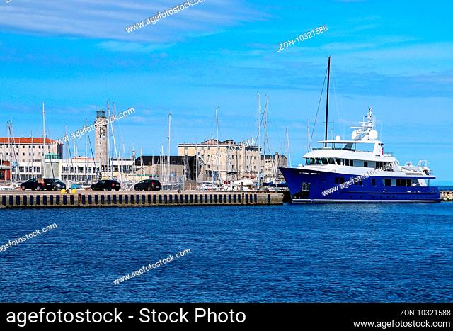 Port and lighthouse in Trieste, Italy. Trieste is the capital of the autonomous region Friuli-Venezia Giulia