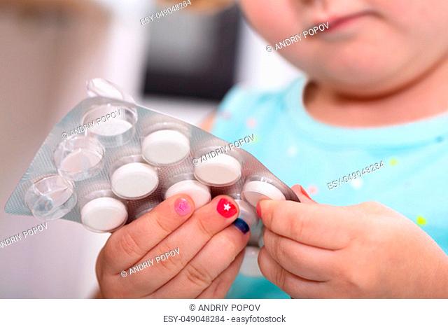 Close-up Of Girls Hand Removing Tablet From Blister Pack
