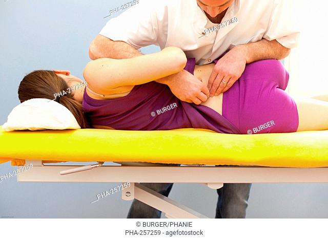 Structural osteopathy session on a woman with low back pain