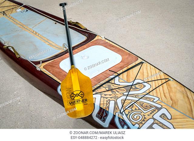 Fort Collins, CO, USA - July 29, 2017: Preparing for a paddling expedition in a driveway - Starboard Expedition paddleboard with a custom made hatch to storage...
