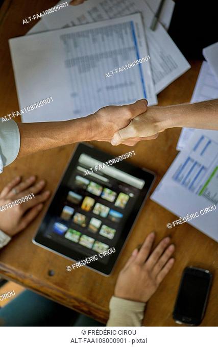 Business associates shaking hands during meeting