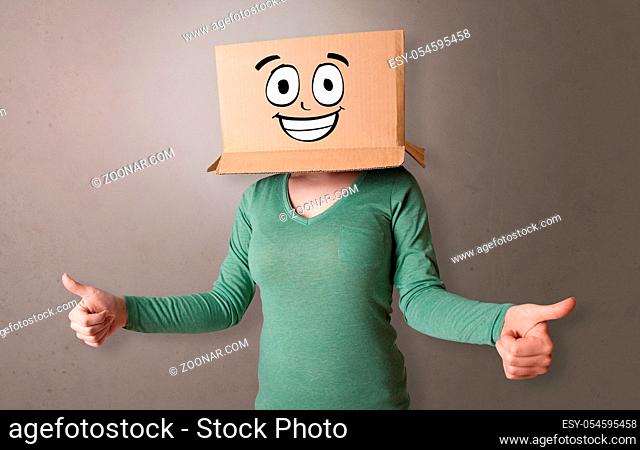 Young girl standing and gesturing with a cardboard box on her head