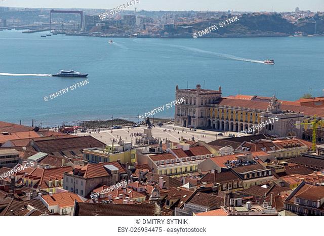 view on travel city Lisbon from top place of castle sao jorge. roofs, river tejo, brige 25 april, ships in summer day