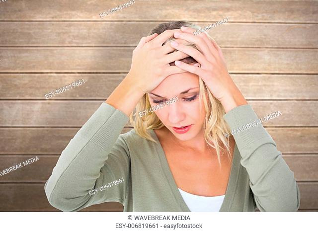 Composite image of confused young blonde with hands on head