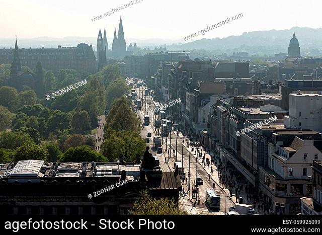 Aerial view with backlight form Scott monument over medieval city Edinburgh with Princes street and gardens