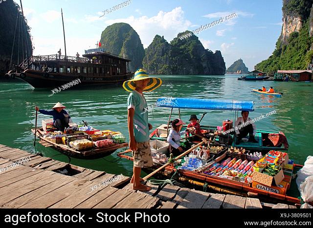 Floating market, vendor in boat with food, Halong Bay, Vietnam