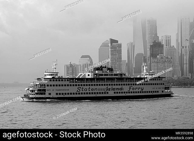 New York NY - USA - Aug 14 2019: Staten Island Ferry on the New York Harbor against of Lower Manhattan skyscrapers