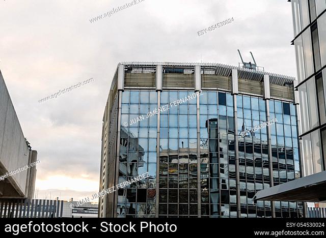 Low angle view of modern architecture office buildings in Castellana Avenue in Madrid against cloudy day