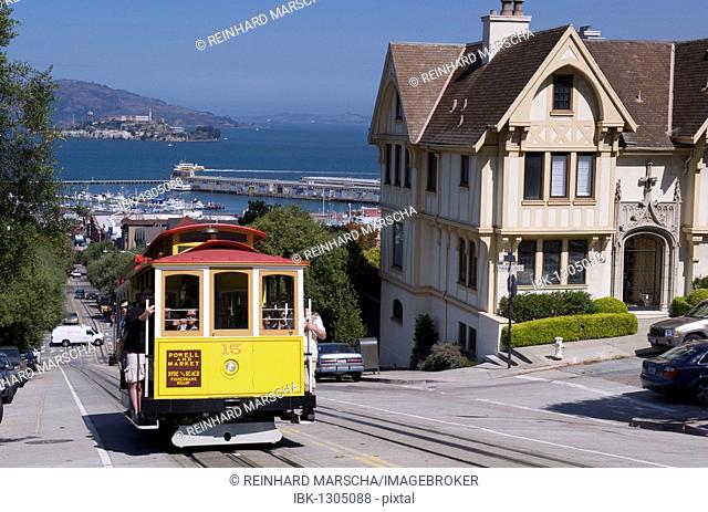 Cable Car and Victorian mansion in Hyde Street, corner Francisco Street, view of Alcatraz, San Francisco, California, USA
