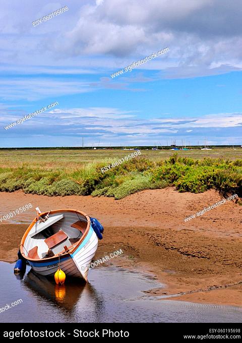 Beached blue and white Boat Blakeney, North Norfolk coast East Anglia. Ample copy space. High quality photo