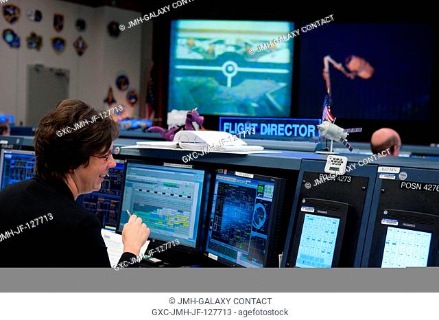 Flight director Holly Ridings monitors data at her console in the space station flight control room in the Mission Control Center at NASA's Johnson Space Center...
