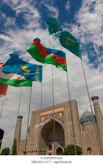 Uzbekistan, Samarkand, Registan, Flags flying before Mosque