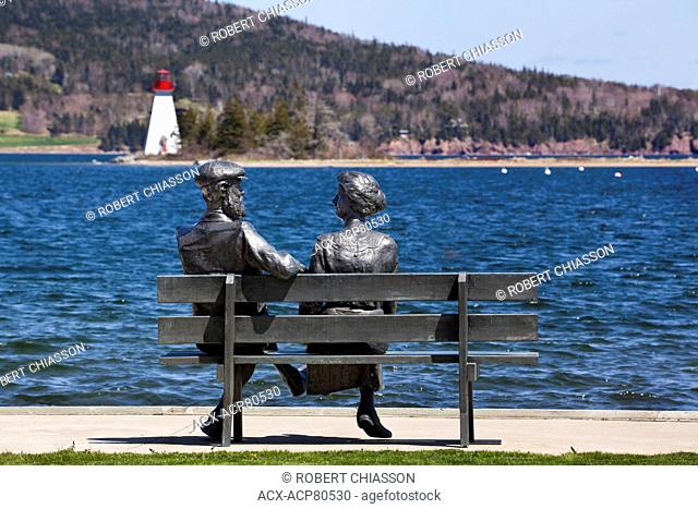 Life-size bronze statue of Mabel and Alexander Graham Bell on a park bench in front of Bras d'Or Lakes, Baddeck, Nova Scotia