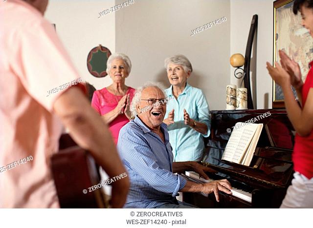 Elderly people making music in retirement home